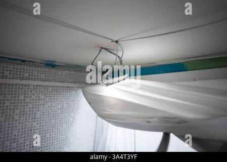 Replacing the stretch ceiling in the bathroom. Stock Photo