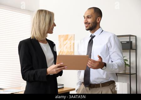 Coworkers with tablet working together in office Stock Photo