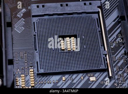 A close-up view of an AM4 CPU socket on a motherboard. This detailed image shows the precision of the socket pins and the structure, perfect for hardw Stock Photo