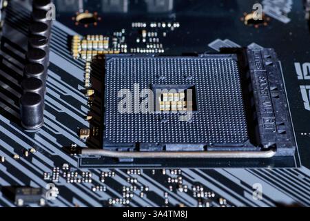 A close-up view of an AM4 CPU socket on a motherboard. This detailed image shows the precision of the socket pins and the structure, perfect for hardw Stock Photo