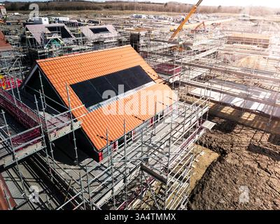 The roof of a new build houseunder construction on a construction site with roof integrated or In-Roof solar panels for cheap and sustainable energy i Stock Photo