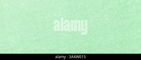 Light green matte background of suede fabric, closeup. Velvet texture of seamless mint woolen felt. Stock Photo