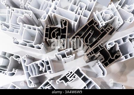 Samples of various profiles of PVC windows on the window. Industry Stock Photo