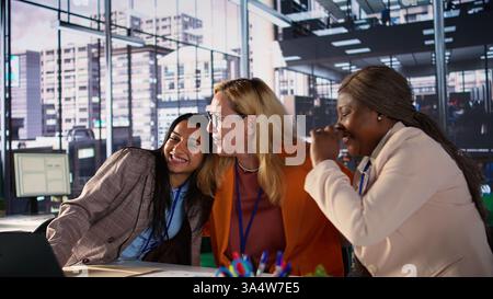 Powerful satisfied entrepreneurs hugging and congratulating each other after hard work and dedication, achieving great things together in a men dominated business industry, success story. Camera B. Stock Photo
