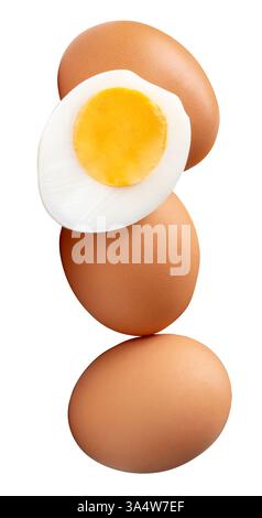 Front view or top view of raw brown chicken eggs and cooked or boiled chicken egg with egg yolk in half in pile or stack is isolated on white Stock Photo