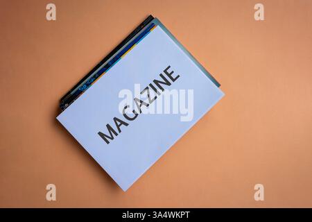 Stack of magazines with word Magazine on white cover. Top view. Stock Photo