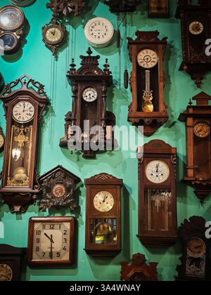 Vintage Wooden Clocks Displayed on a Wall Stock Photo
