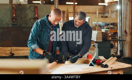 Carpentry, planning and men in workshop for woodwork on furniture, restoration and lumber manufacturing. Construction, measure and carpenters in Stock Photo