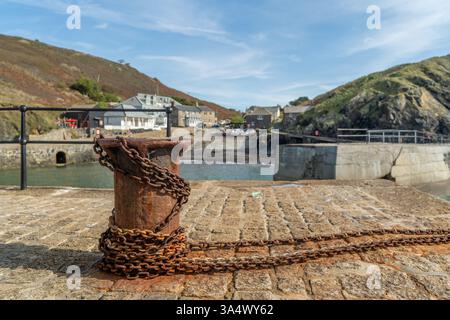 The picturesque harbour of Mullion Cove on the Lizard Peninsula with it's famous rusty old capstan and chain Stock Photo
