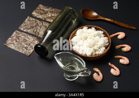 Composition with different ingredients for preparing tasty sushi rolls on dark background Stock Photo