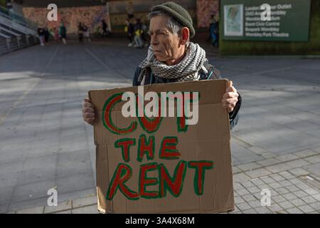 A protester holds a sign reading 