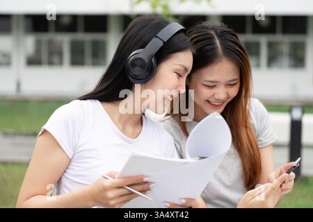 Study Buddies and Education. Two students engaged in collaborative learning, sharing insights and resources while enjoying their study session. Stock Photo