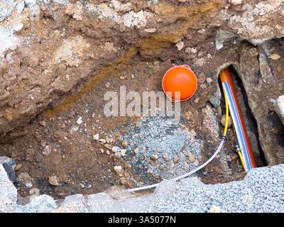 Laying a fiber optic cable for fast internet on the street Stock Photo