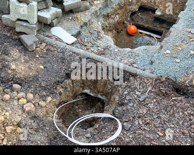 Laying a fiber optic cable for fast internet on the street Stock Photo