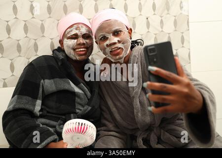 Black females making skincare routine in bathroom at home Stock Photo