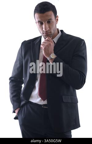 Middle Eastern businessman in a sharp suit stands in a clean white studio, conveying confidence and professionalism. Ideal for corporate branding, leadership profiles, and business presentations. Stock Photo