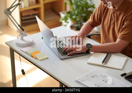 Cropped image of a Vietnamese software developer focused on a project at a desk in a home office. Great for technology, coding, and remote-work themed campaigns. Useful for startups, IT services, and digital product marketing. Stock Photo