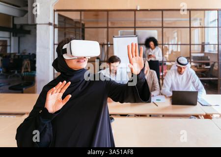 Multiethnic corporate team meets in the office to plan a strategic marketing campaign. Diverse professionals collaborate in a modern workspace to brainstorm ideas. Stock Photo