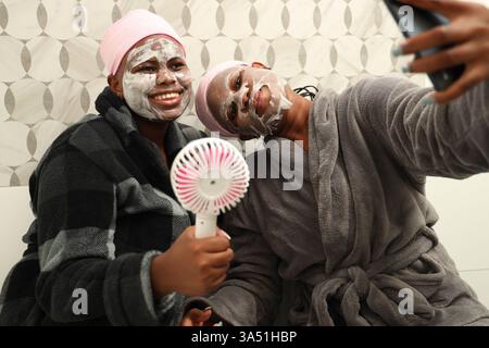 Black females making skincare routine in bathroom at home Stock Photo