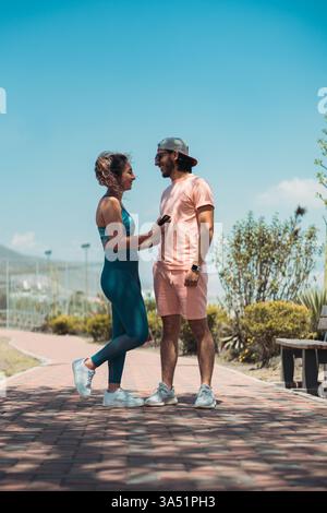 Two people in a sunny park share a close, affectionate moment as they touch and look into each other’s eyes. This outdoor lifestyle image highlights romance, diversity, and connection in everyday moments. Ideal for couples, dating, wellness, and lifestyle campaigns. Stock Photo