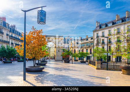 Porte Guillaume Gate Dijon's triumphal arch on Place Darcy Square with green trees in pots in old town Dijon city historical centre in sunny summer da Stock Photo