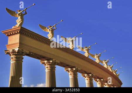 A row of roman winged goddesses with trumpets on a stand Stock Photo