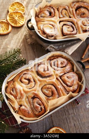 Homemade baked cinnamon rolls in two baking pans Stock Photo