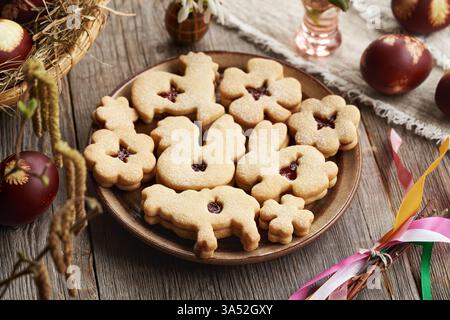 Linzer Easter cookie in the shape of animals filled with strawberry marmalade, with Easter eggs Stock Photo