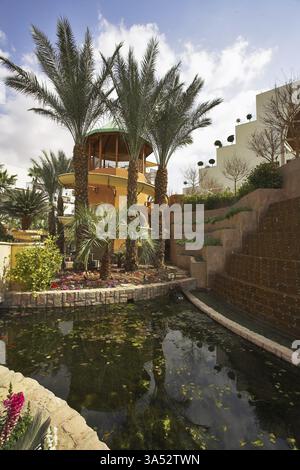 A magnificent fountain and a tower for descent in pool in a court yard of fine hotel Stock Photo