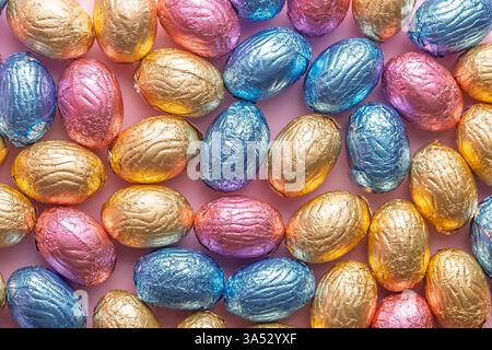 Chocolate easter eggs wrapped in multi colored foil. Top view. Stock Photo