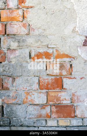 Rough wall displays a pattern of bricks with different colors and ...