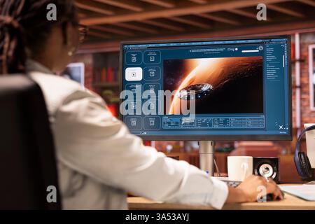 Woman at home using generative artificial intelligence program generating videos using diffusion models, close up. African american person in living room using AI virtual assistant producing clips Stock Photo