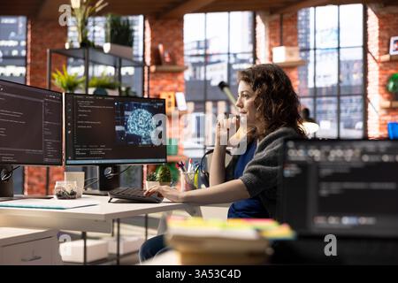 Admin writing code on PC and doing maintenance on artificial intelligence neural networks computerized model. Woman tech support expert doing checkup on AI systems, data science. Stock Photo