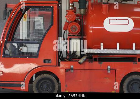 Close-up of the red body and the water tank of a fire engine or small fire-fighting vehicle Stock Photo