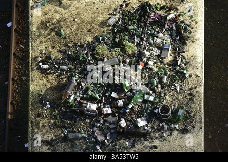 Bottle waste from drunk beer bottles lies on an intermediate roof in a party zone Stock Photo