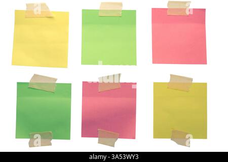 Six colorful sticky notes attached with adhesive tape create a vibrant and organized display on a clean white background. Isolated Stock Photo