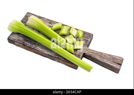 Sliced uncooked celery sticks on wooden cutting board isolated on white background, top view. Stock Photo