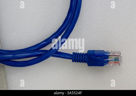 Ethernet patch cable rolled up on white Stock Photo
