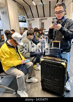 Taipei, Taiwan, Crowd People, Tourists, Traveling, Taipei Main Train Station, Sitting inside, Using Smart Phones, Men Waiting for High Speed Train Stock Photo