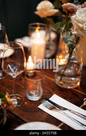 Elegant Table Setting with Candles and Flowers Stock Photo