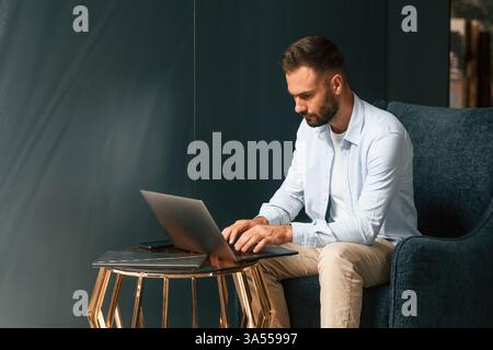 Businessman is sitting and working by using laptop. Stock Photo