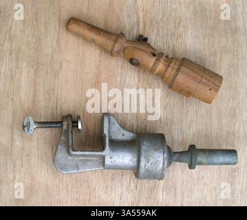 Wig making equipment. Part of a wooden adjustable block holder and a metal clamp from a hair weaving frame. Stock Photo