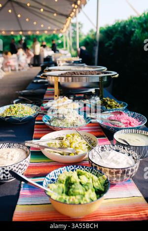 Colorful Mexican food buffet set up for dinner at a summer event Stock Photo