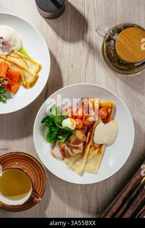 pancakes with chicken fillet sauce and herbs Stock Photo