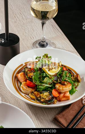 salad with seafood and arugula with lemon and sesame sauce Stock Photo