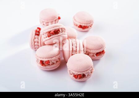 Pink colored. Bunch of macarons on the white surface. Stock Photo