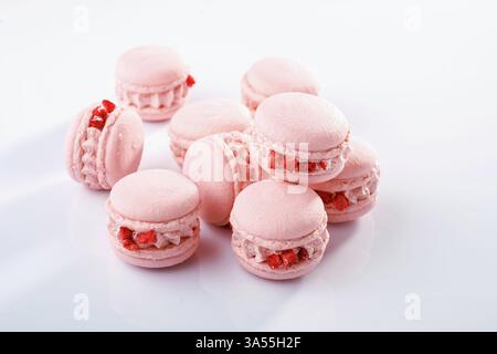 Pink colored. Bunch of macarons on the white surface. Stock Photo
