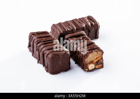 Chocolate bars lie on a white surface, isolated. Stock Photo