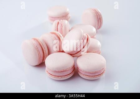 Pink colored. Bunch of macarons on the white surface. Stock Photo