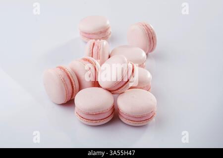 Pink colored. Bunch of macarons on the white surface. Stock Photo